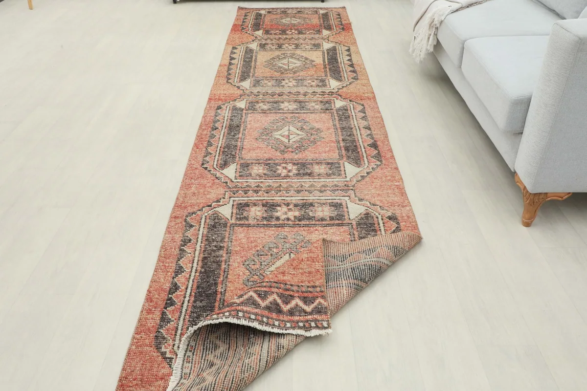 Runner partially folded to demonstrate its flexibility and construction, laid out in a room.