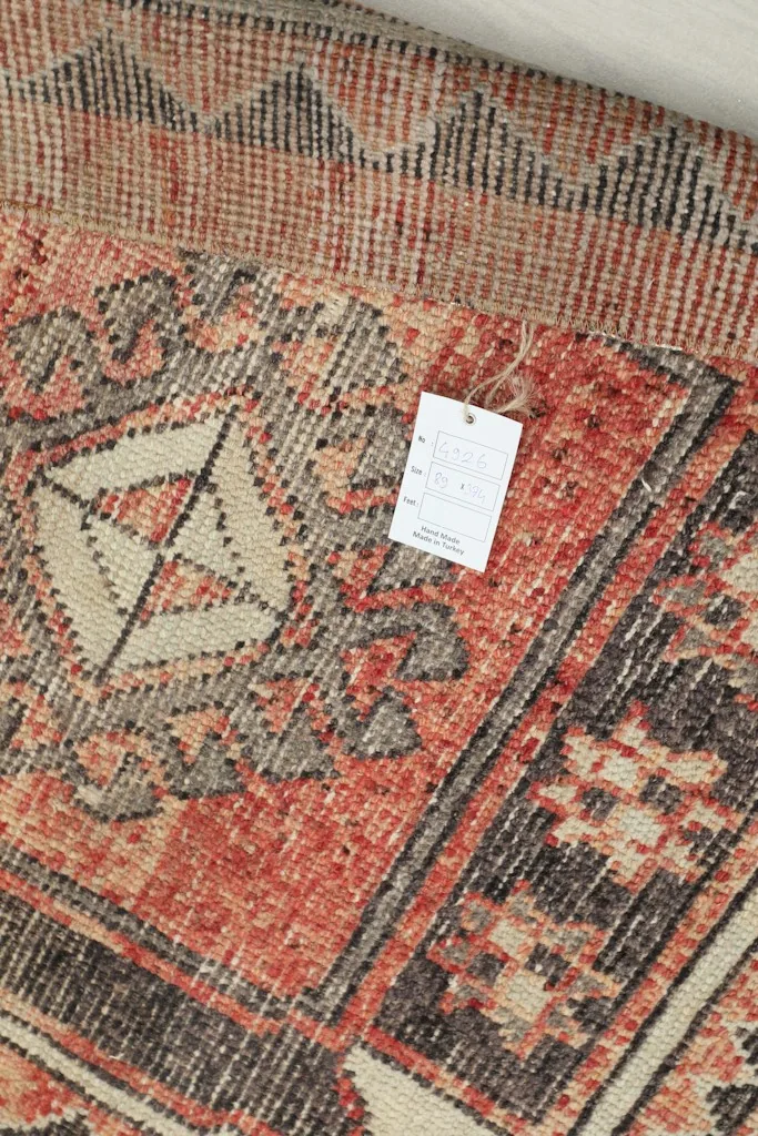 Detail of the runner's pattern with a small product tag visible near the edge.