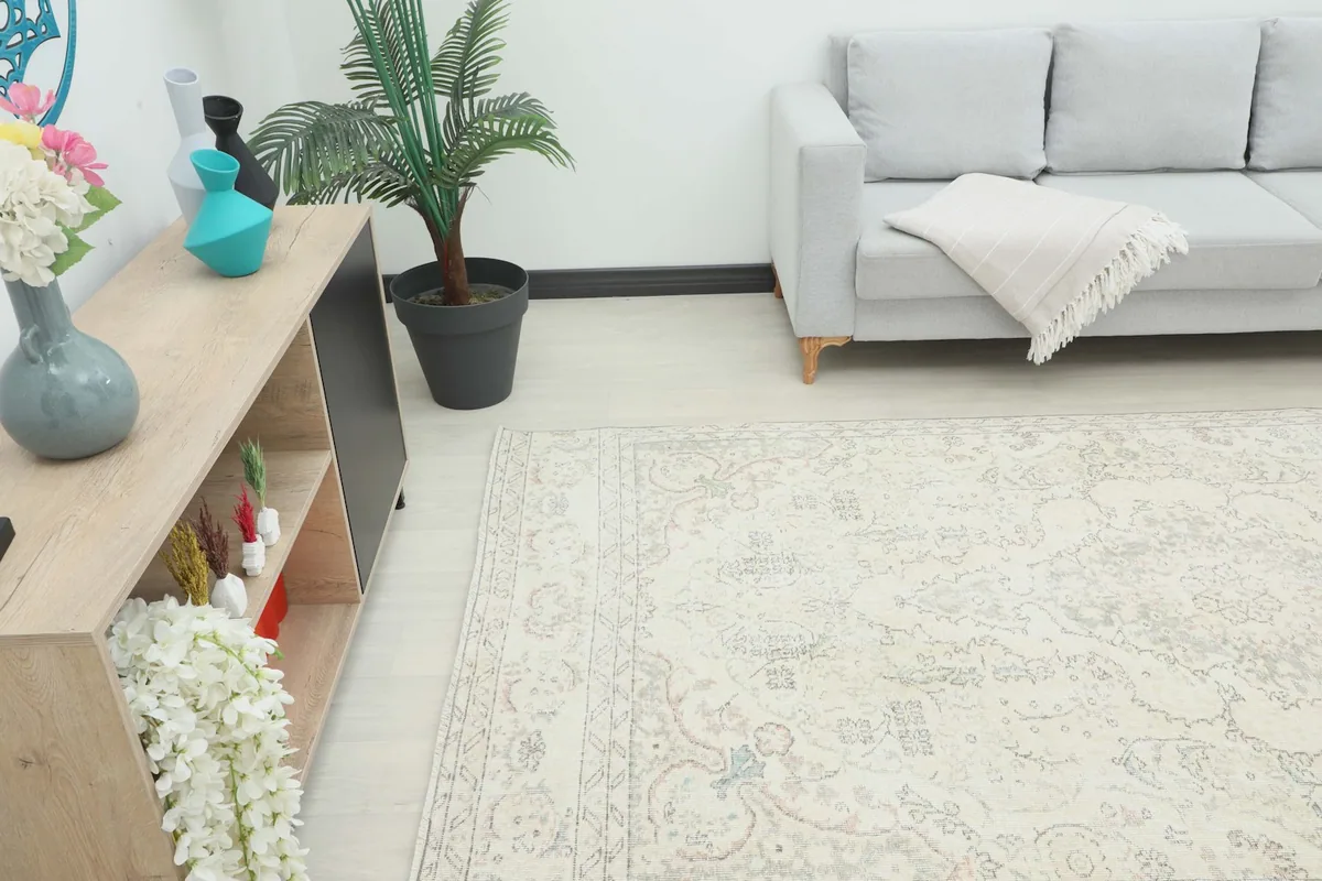 Angle view of the ivory area rug in a room, showing its length and placement