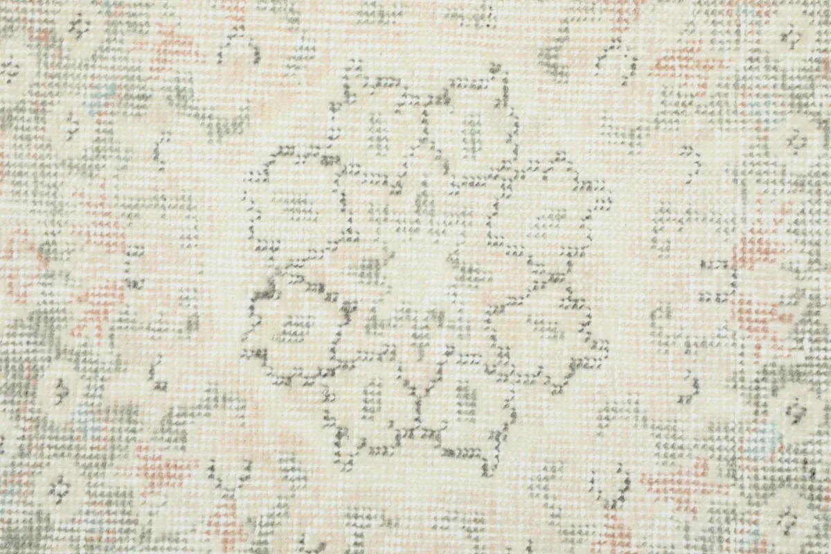 Close-up of the intricate floral and geometric patterns within the rug