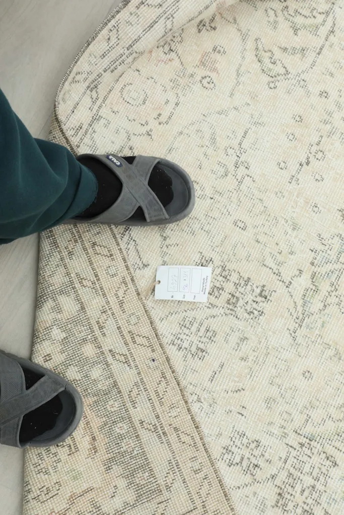 A person's feet on the rug, showing scale and the rug's texture