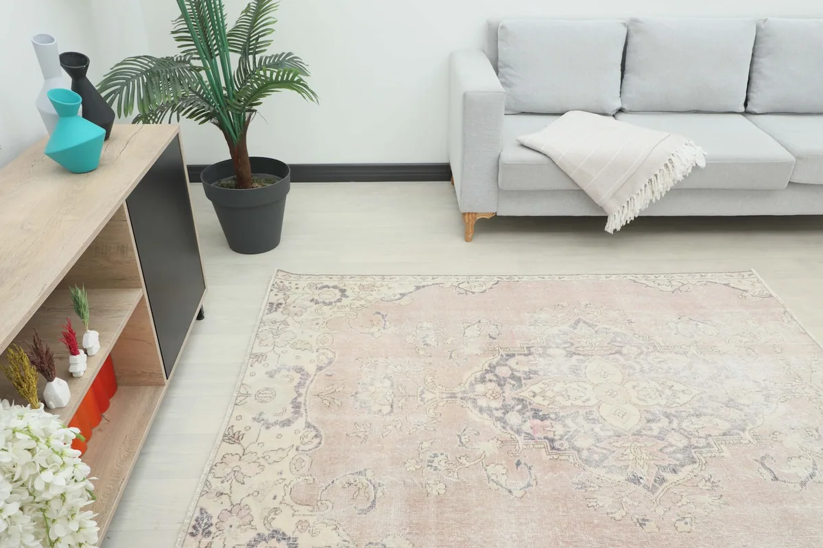 Angled view of the Muted Rose Medallion Anatolian rug placed in a room setting.