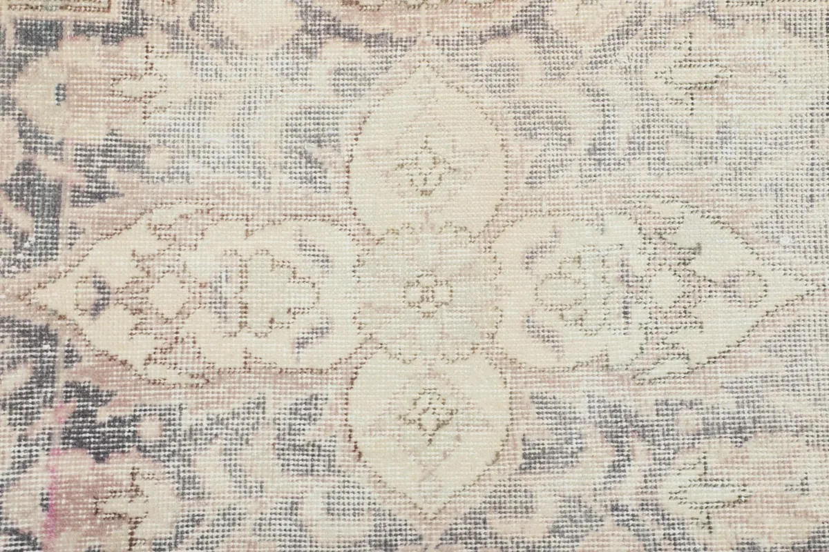 Close-up of the intricate floral and geometric motifs within the rug's central design.