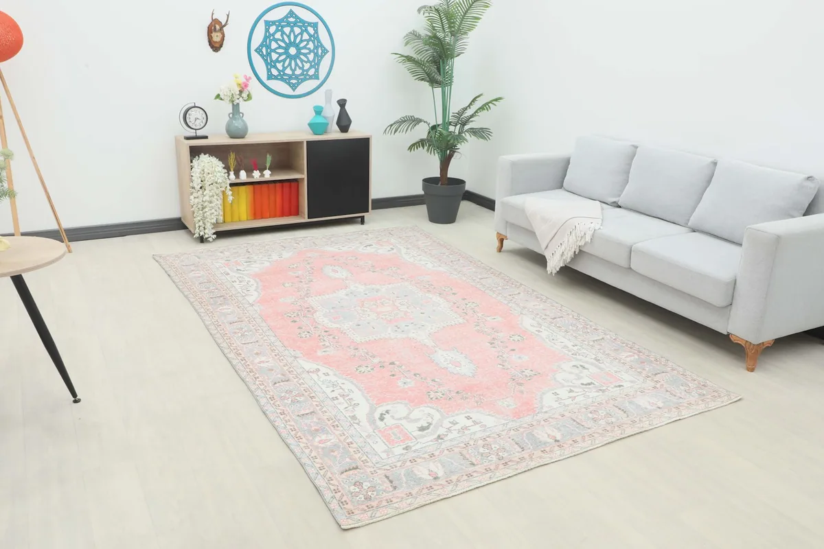 Vintage Anatolian rug displayed in a modern living room setting with a light gray sofa.