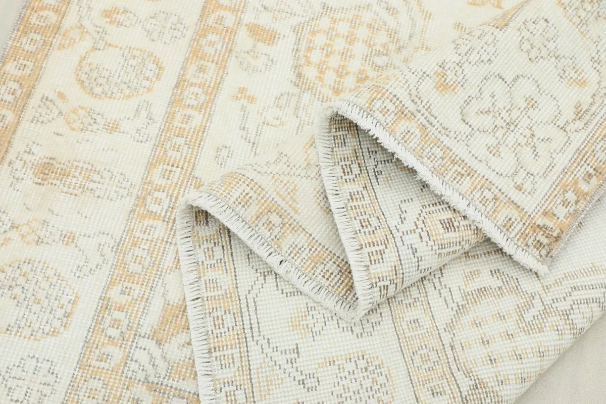 Multiple folds of the rug showcasing its flexibility and the consistent pattern on the reverse.