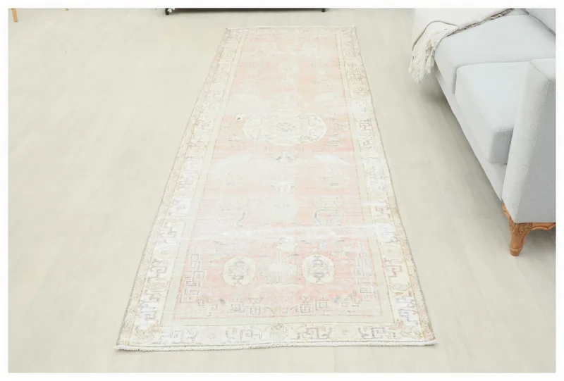 Full overhead view of the 3'3" x 10'2" vintage Anatolian runner rug with rose field and ivory border.