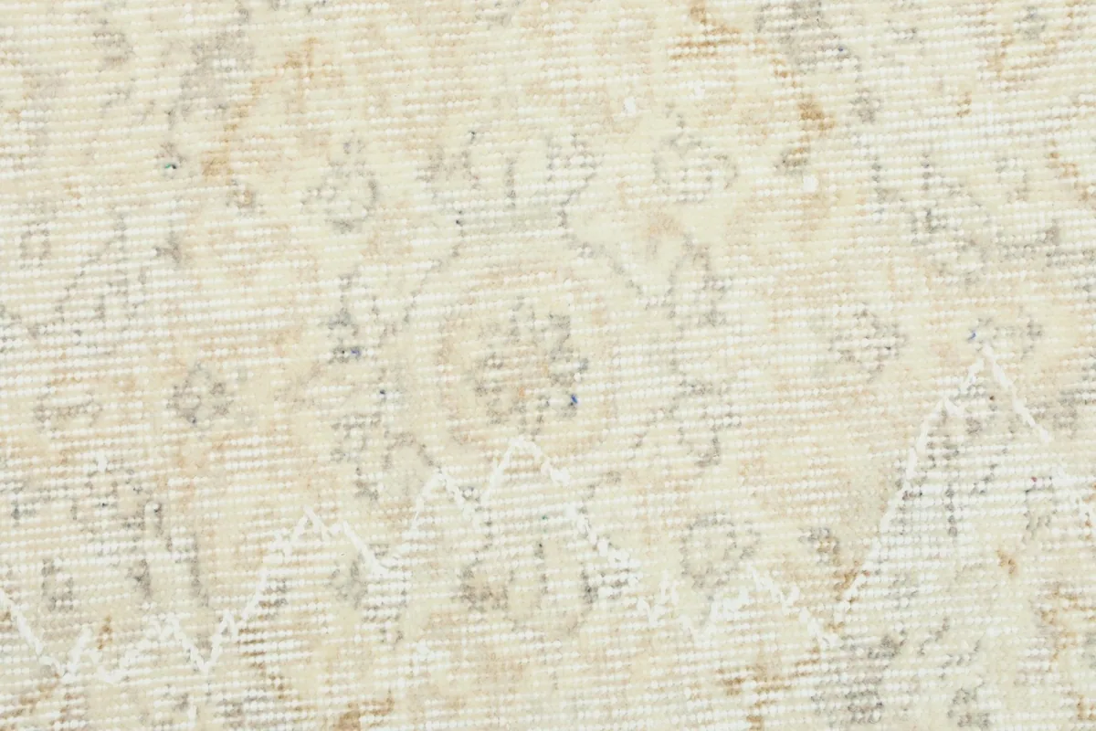 Extreme close-up of the low wool pile, showing the hand-knotted construction and gentle patina.