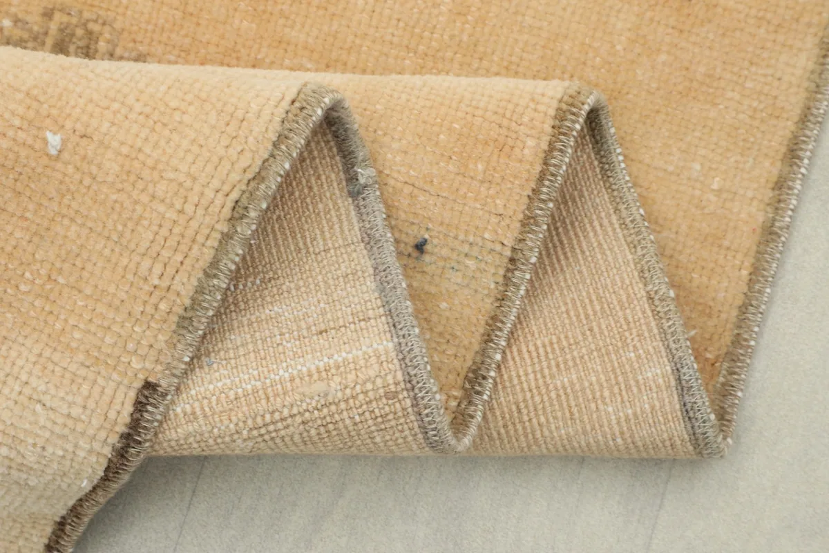 Detail of the rug's backside, showing the tightly woven cotton foundation and craftsmanship