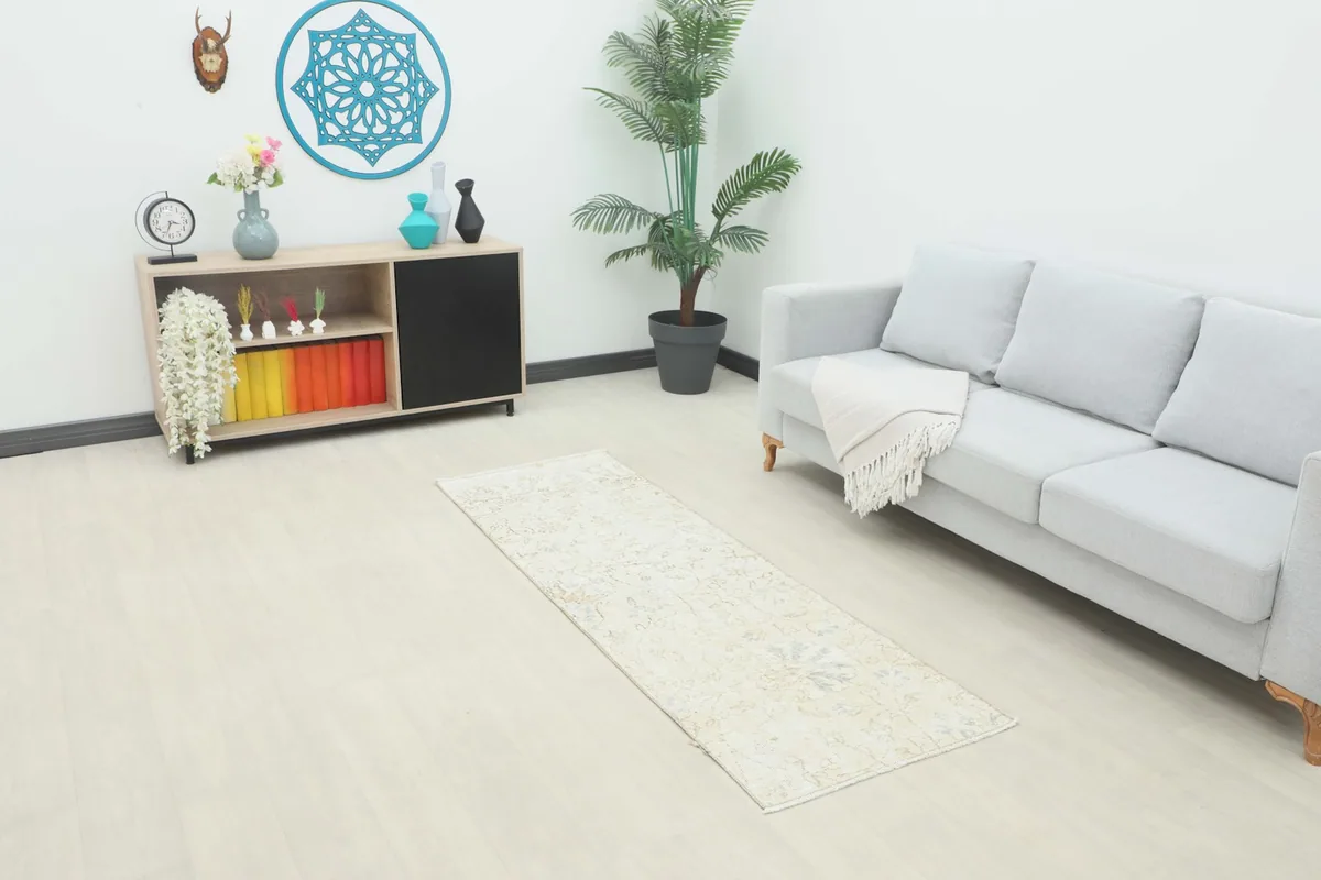 Vintage Anatolian runner rug displayed in a room setting with a light sofa and minimalist decor.