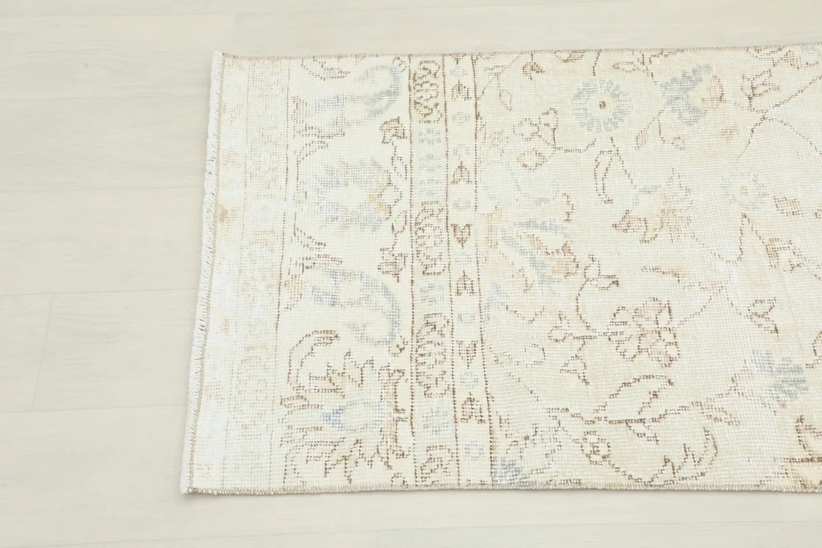 Detail of the rug's border, showcasing the hand-knotted construction and gentle color variations.