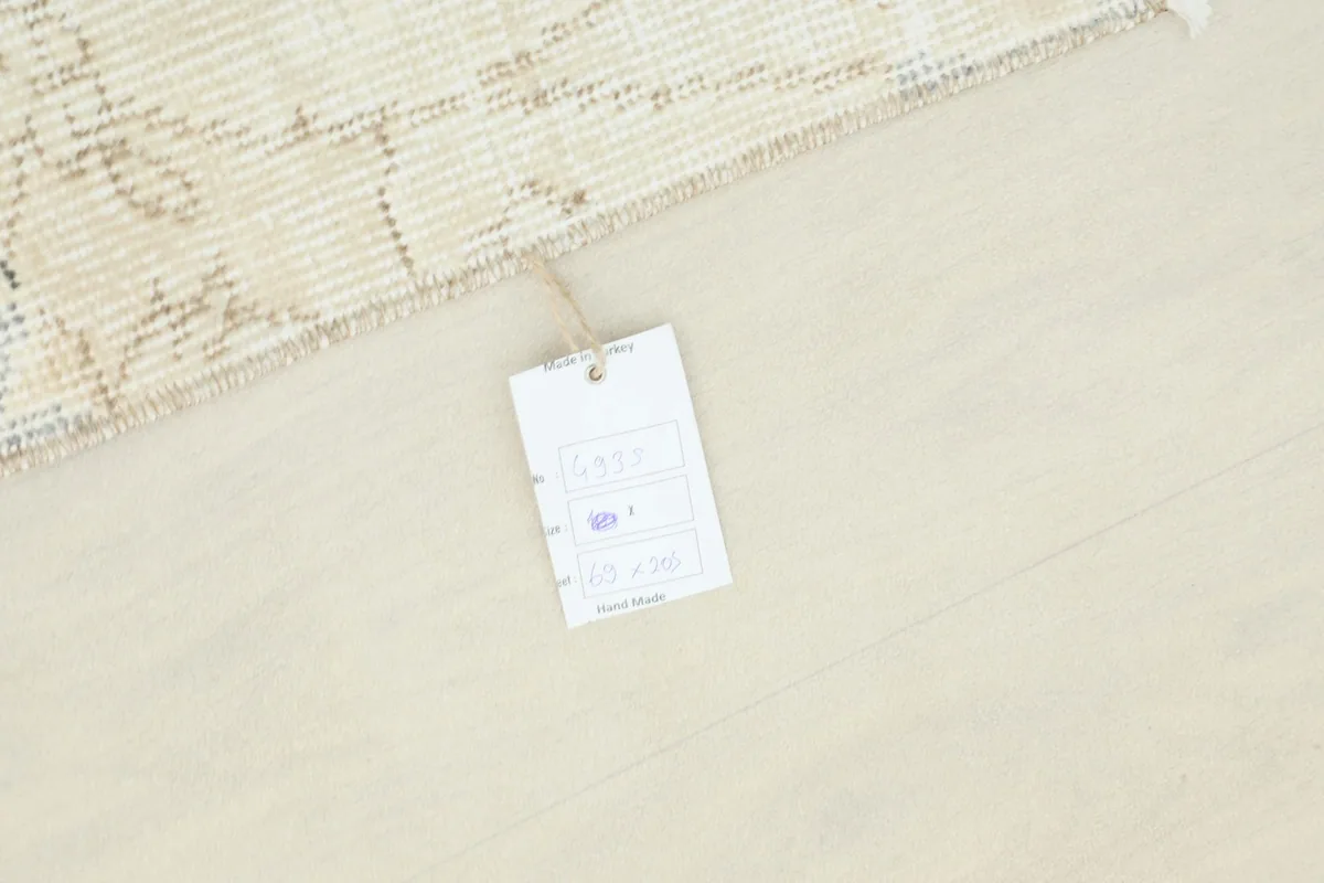 Overhead view showing a small tag on the floor next to the runner, indicating its unique nature.