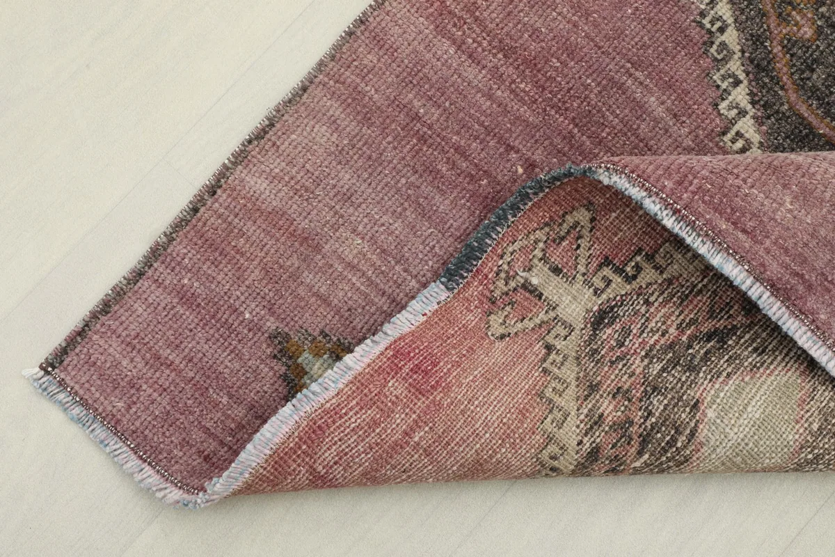 Corner of the runner folded to show the cotton foundation and the reverse side of the hand-knotted wool