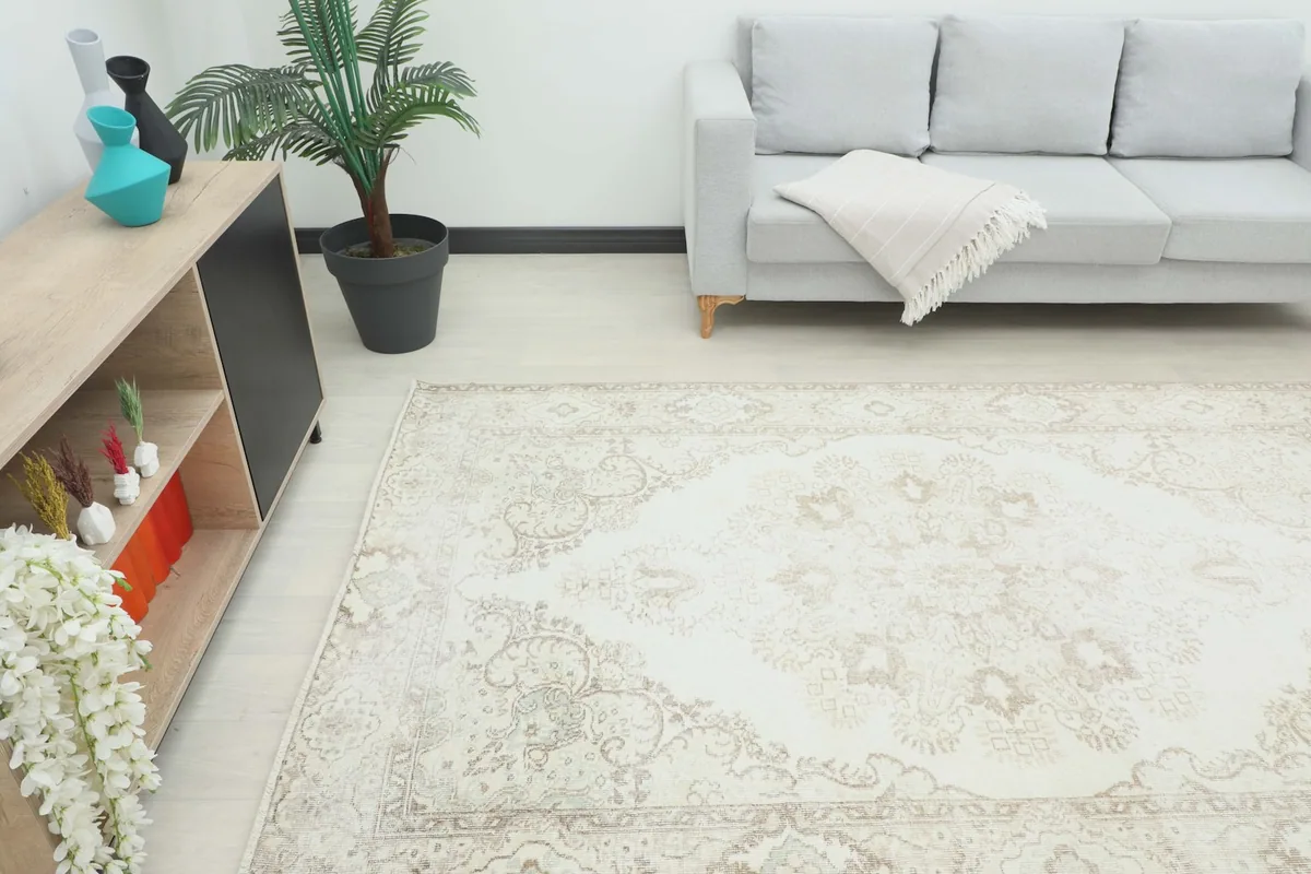 Angle view of the rug in a room, showing its placement relative to a sofa and console table.