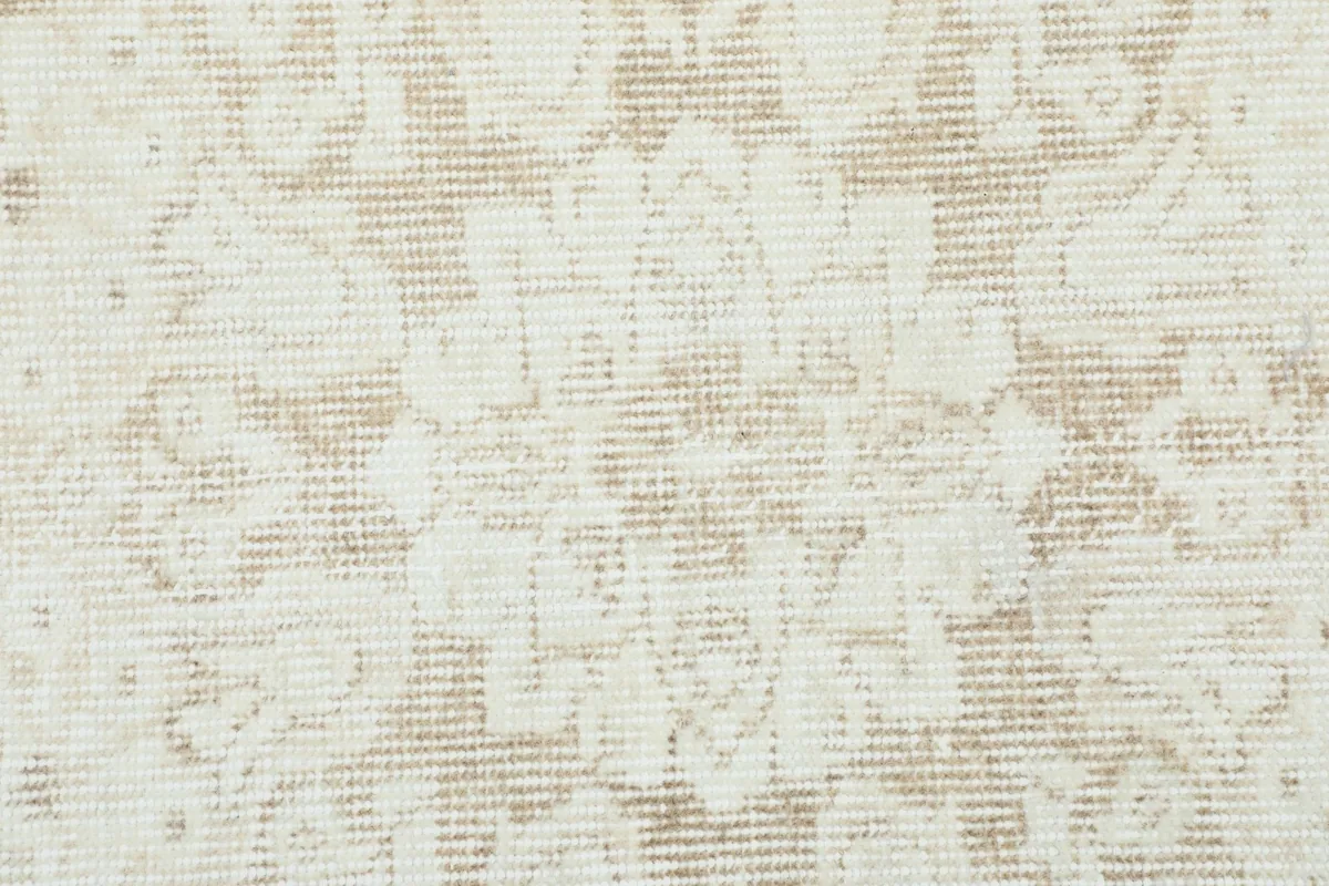 Close-up showing the low wool pile and the intricate hand-knotted texture of the rug.