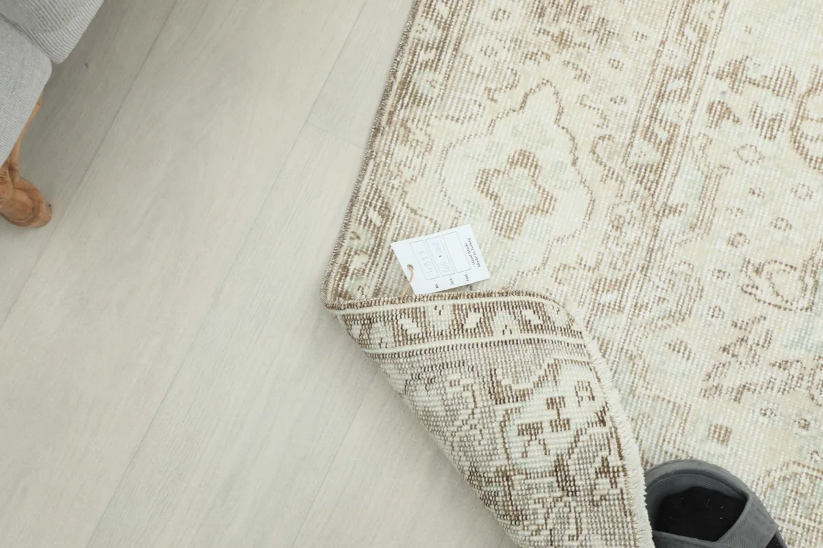 Close-up of the rug's underside and edge, with a small label visible near the corner.