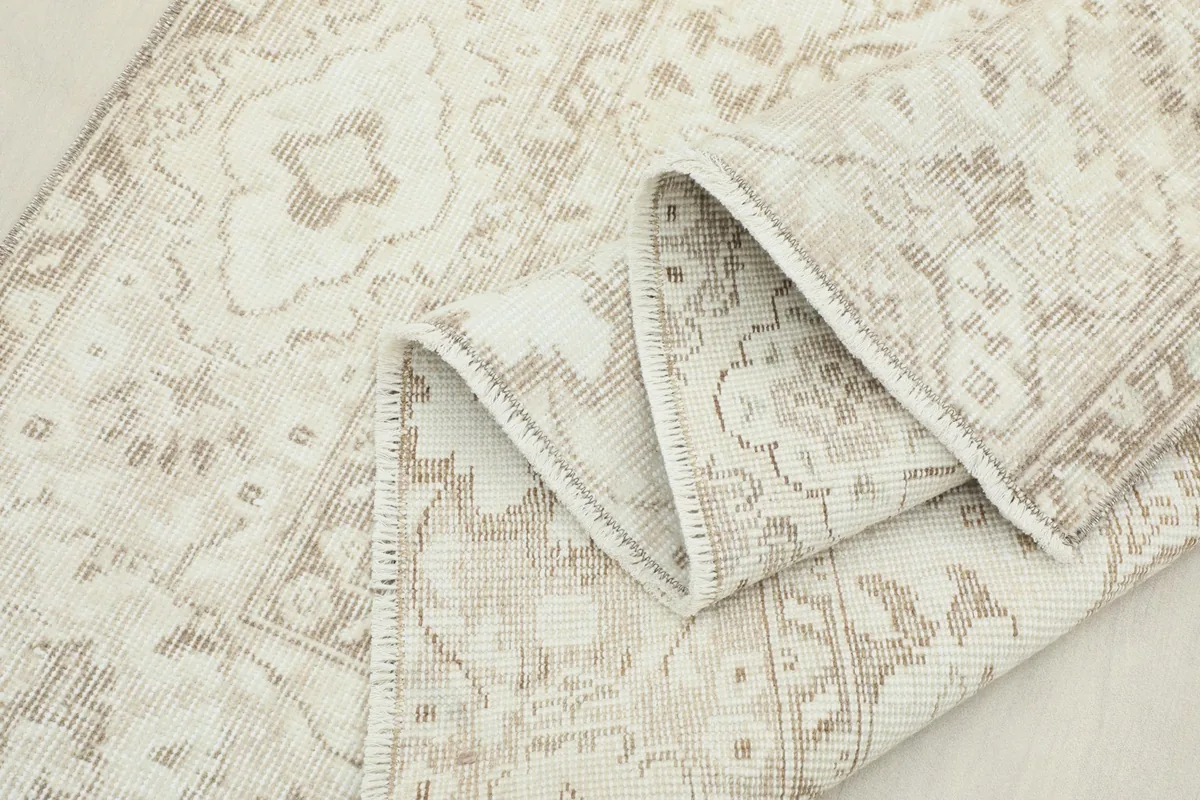 Another view of the rug's corner folded, showcasing the craftsmanship and material.