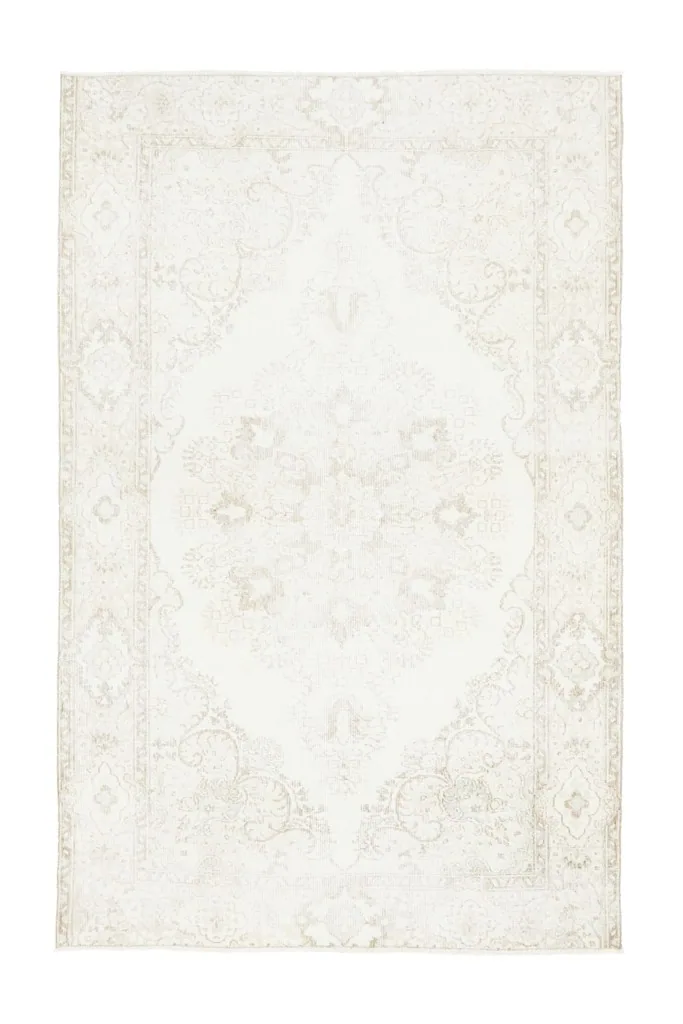Overhead view of the entire rug, clearly showing the full ivory field and beige medallion design.