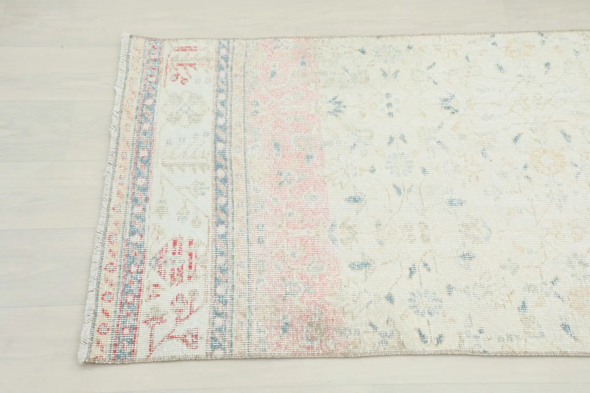 Close-up of the other end of the rug, highlighting the rose and blue patterns.