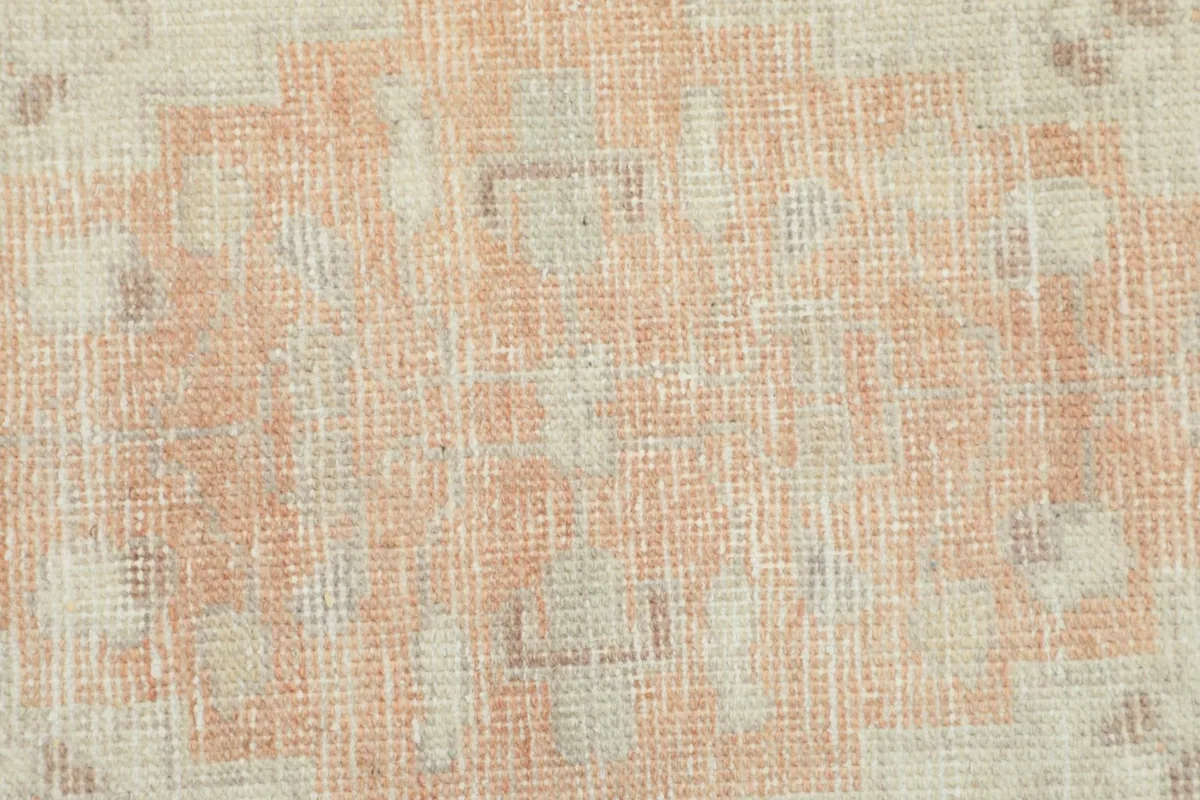 Close-up of the hand-knotted wool pile, showing texture and subtle color variations.