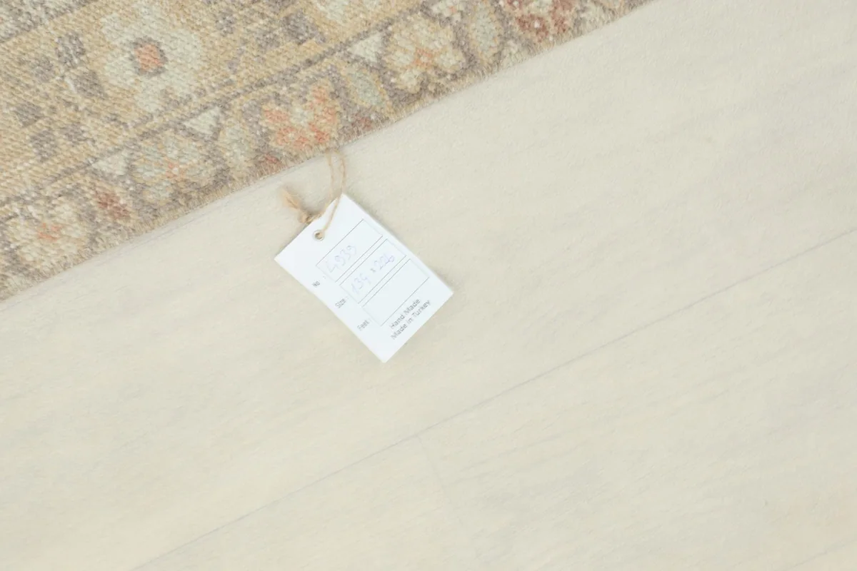 Product tag on the rug, providing information about its origin and material.