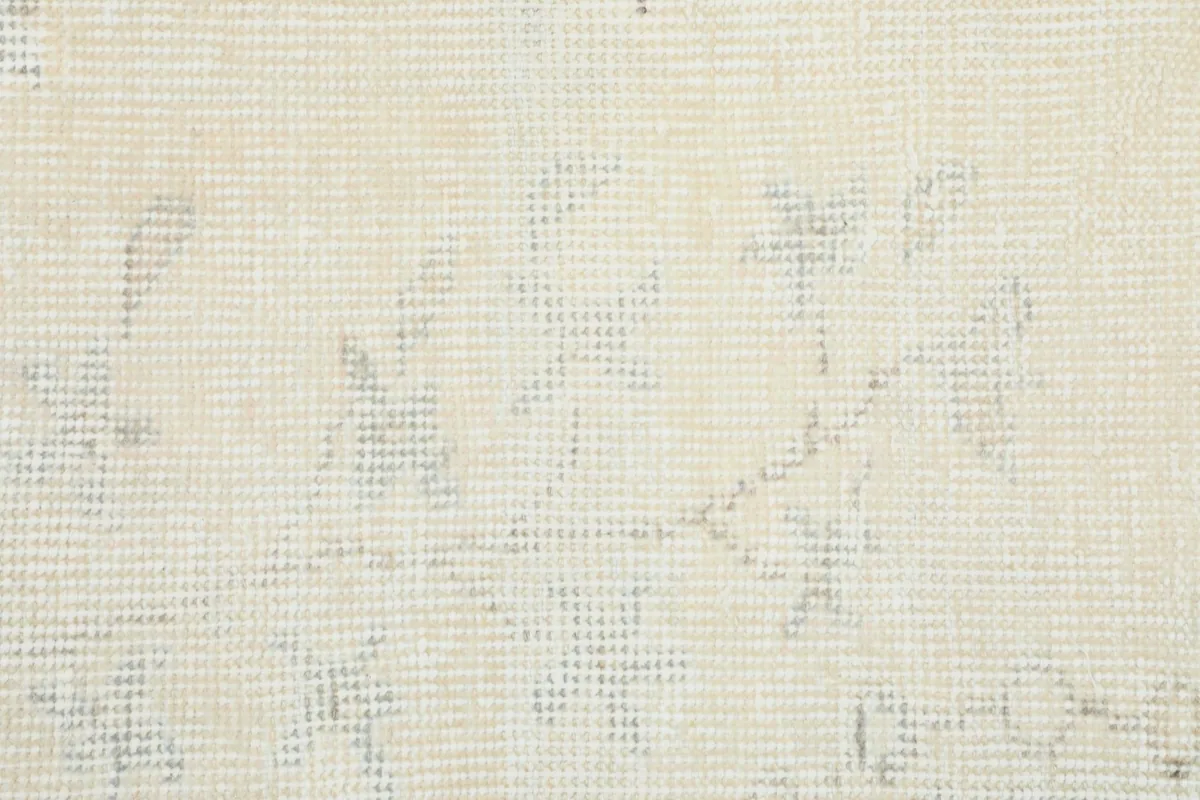 Close-up of the rug's low wool pile, showing individual knots and the cotton foundation beneath.