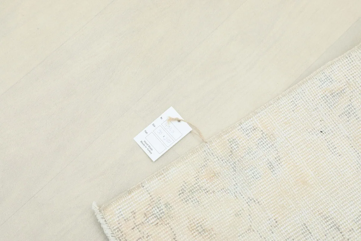 Overhead view showing the rug's back with a product tag, indicating its origin and materials.