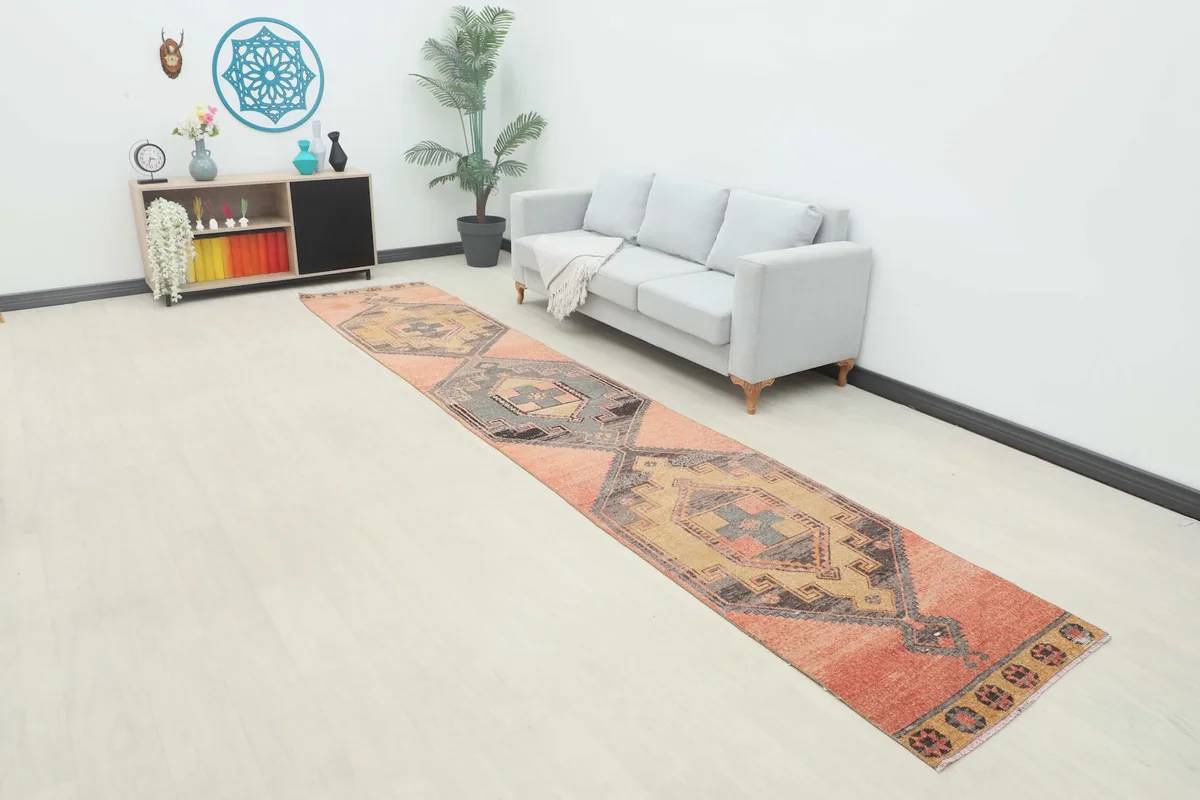 Overhead view of the vintage runner rug in a room setting, showcasing its length and colors.
