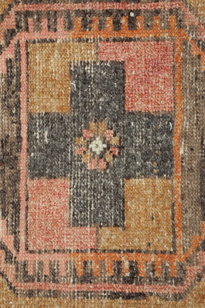 Extreme close-up of a distinct geometric pattern section, revealing the texture and color blend.