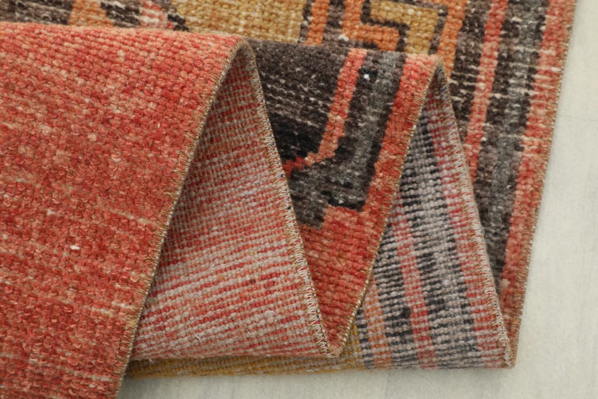 Detailed view of the hand-knotted back of the runner rug, showing the cotton foundation.