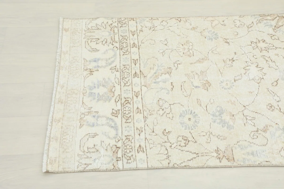 Detail showing the subtle border design and the edge of the vintage runner.