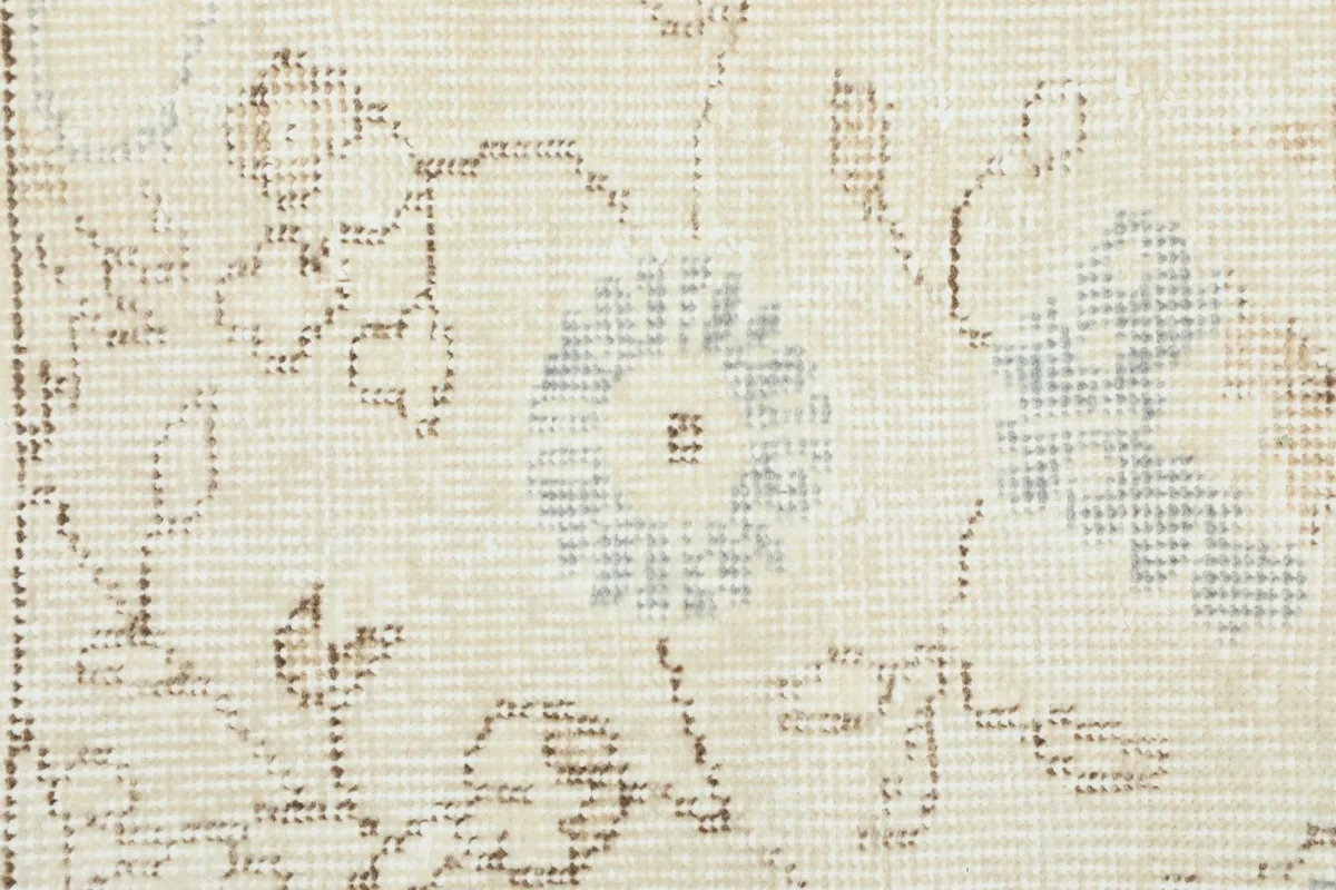 Extreme close-up of the low wool pile and the hand-knotted texture.