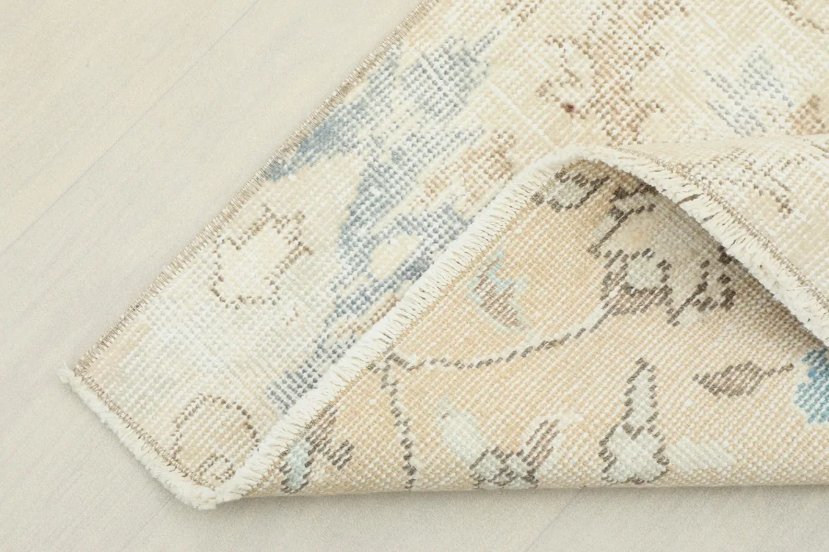 Close-up of the back of the rug, revealing the hand-knotted cotton foundation.