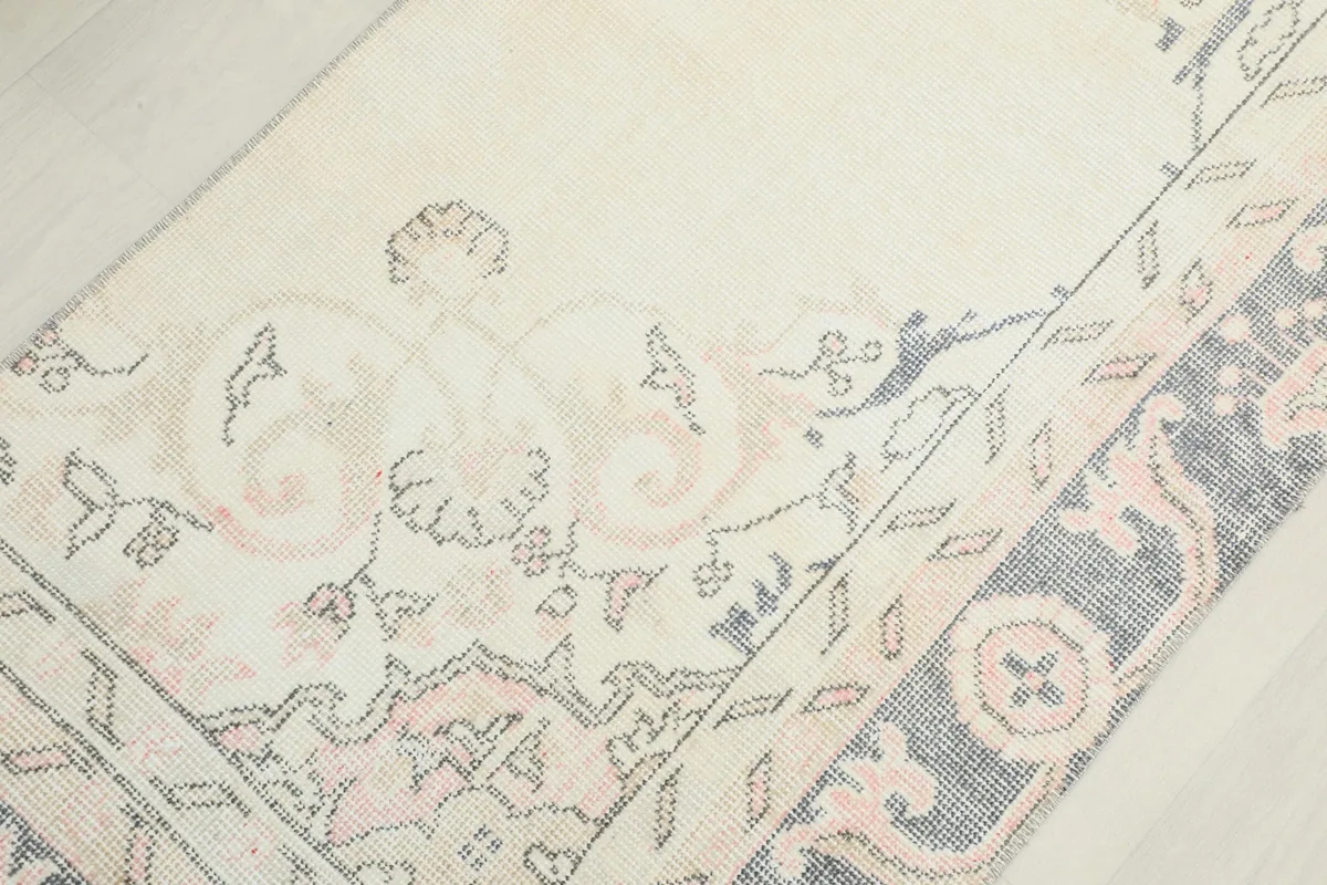 Close-up of the rug's surface, showing the blend of floral and geometric patterns