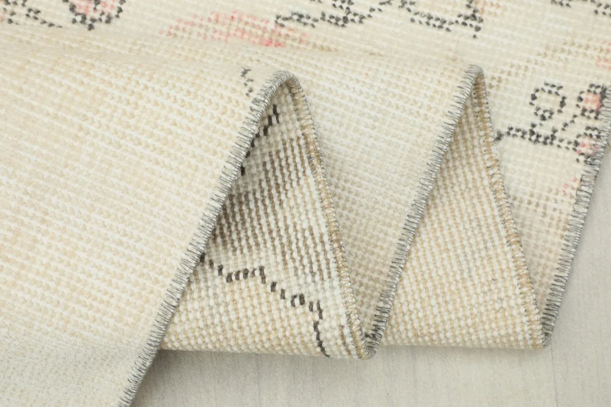 Detailed view of the hand-knotted cotton foundation on the back of the rug