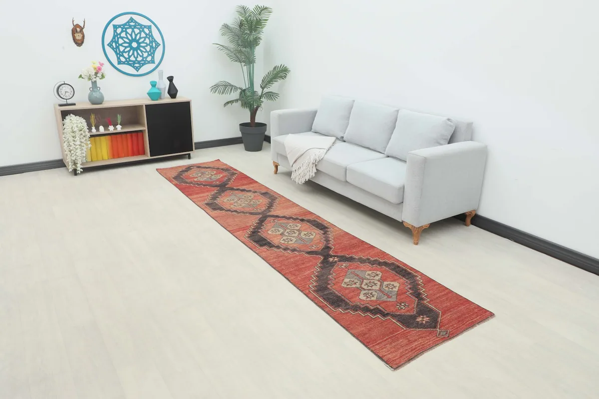 Full view of the rust and charcoal geometric runner rug in a modern living space.