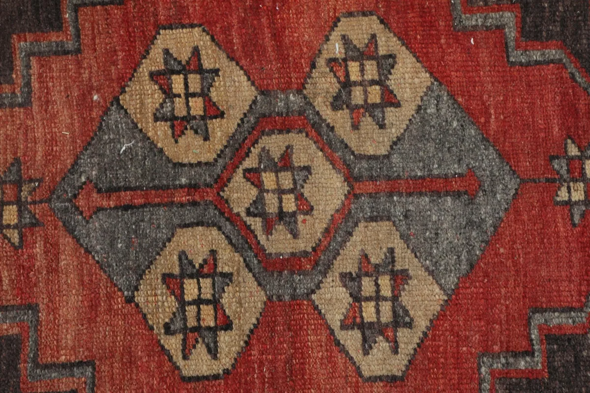 Extreme close-up of the central motif, revealing individual knot work and color variations.