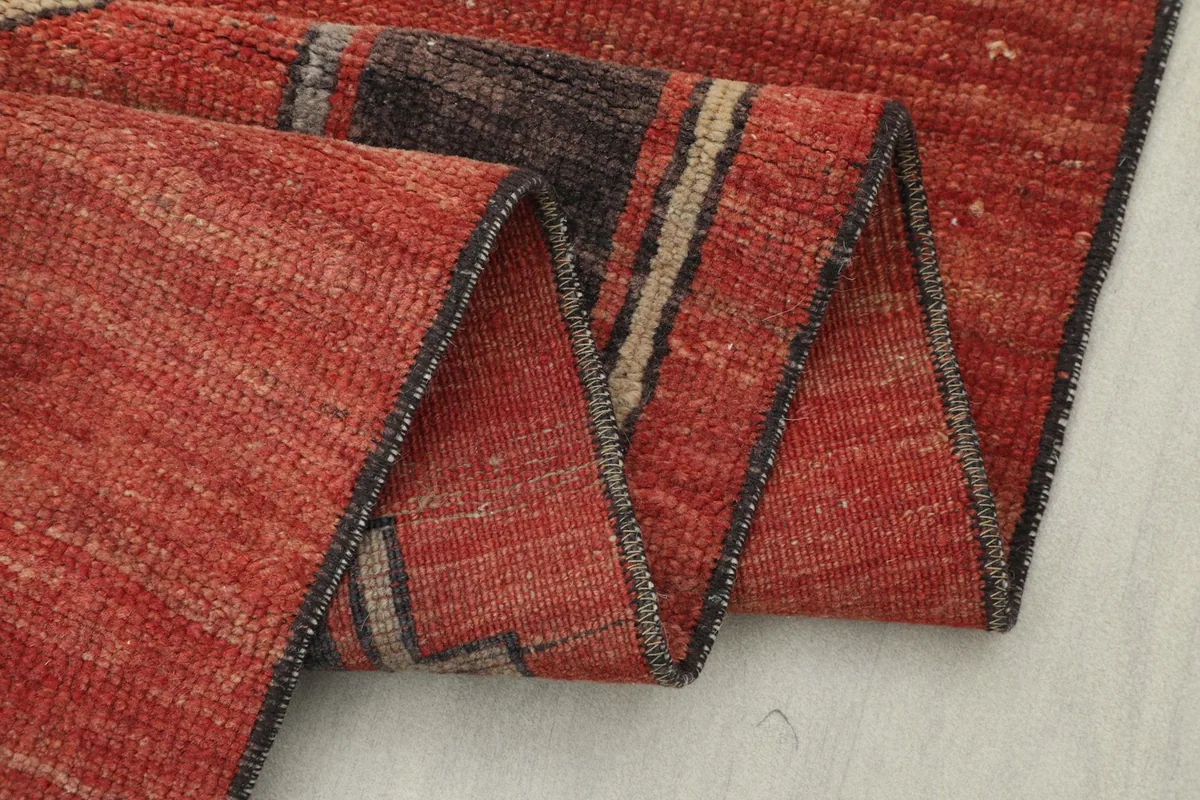 Close-up of the rug's fold, revealing the construction and the reverse side.