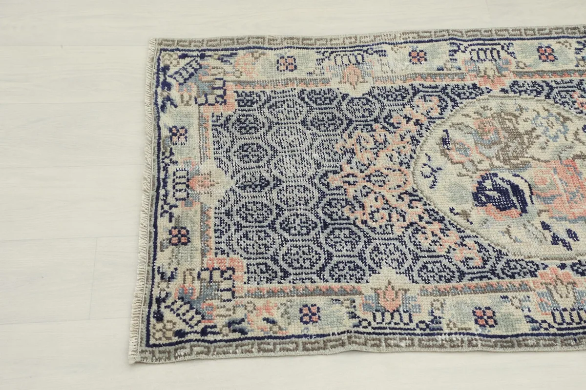 Detailed view of the rug's edge, showing the intricate patterns and colors.