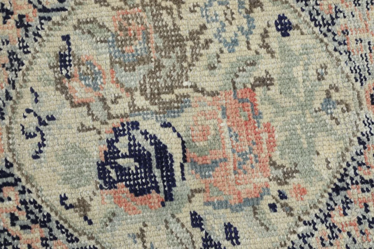 Macro view of the hand-knotted wool pile, revealing the texture and subtle color variations.