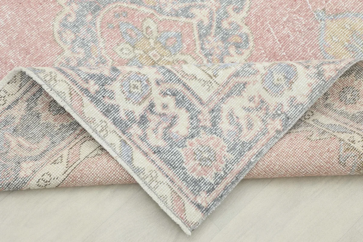 Folded corner of the runner, revealing the hand-knotted construction and wool pile on cotton foundation.