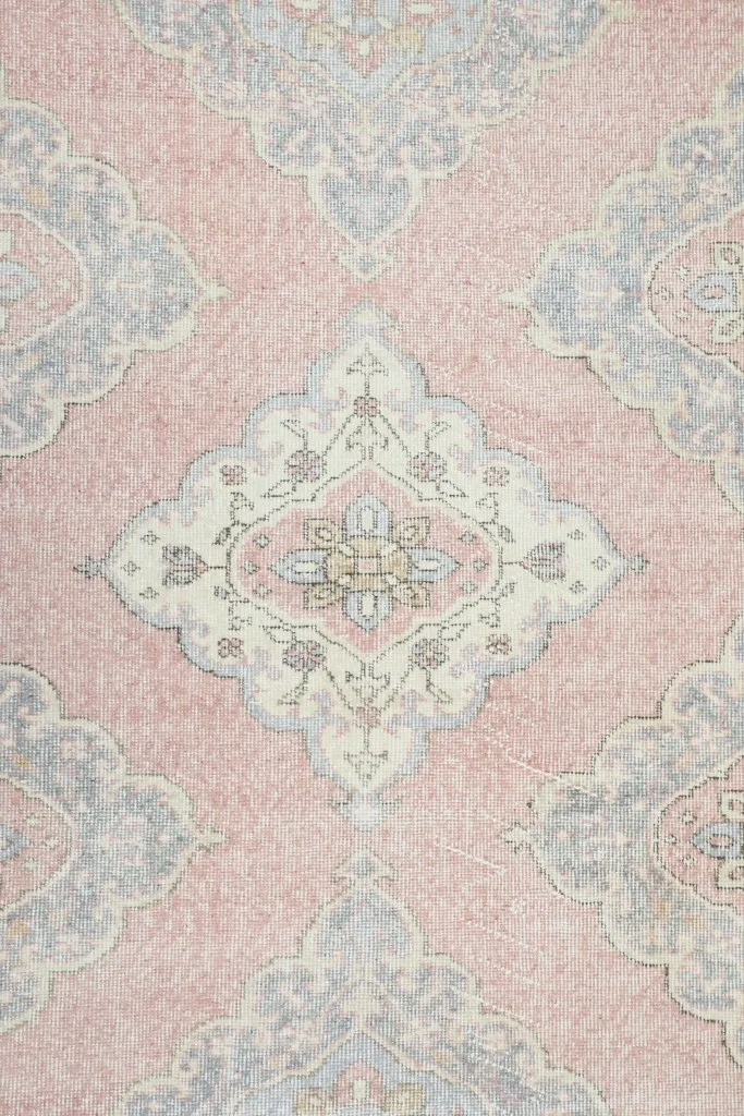 Overhead view showcasing the repeating pink and blue geometric medallion pattern across the runner.