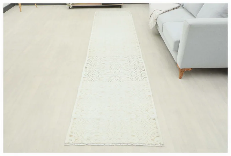 Full top view of the 2'8" x 12'4" cream and tan geometric vintage runner on a white background.