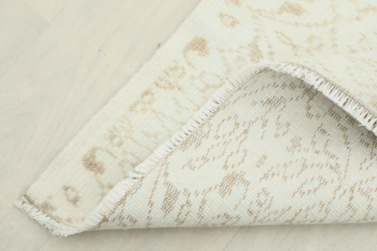Corner of the runner folded to show the hand-knotted wool pile on cotton foundation.