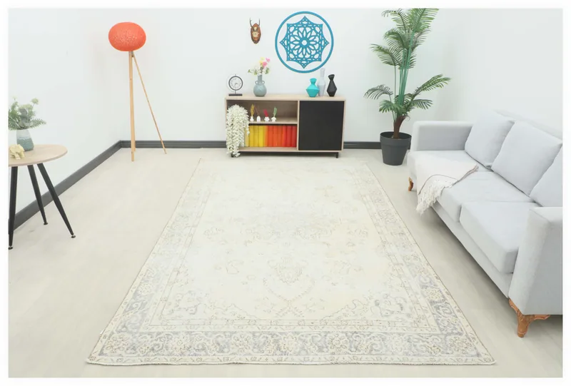 Full top view of the 6'4" x 10'2" ivory gray vintage Anatolian area rug on a white background.