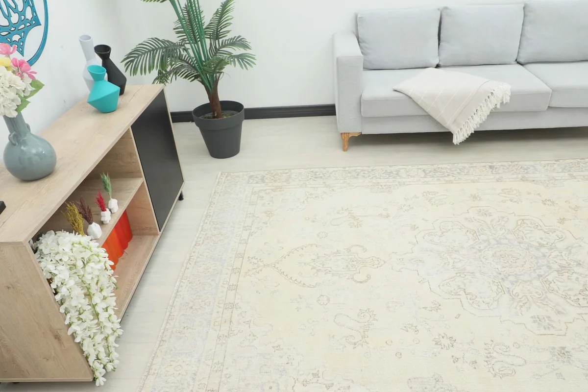 The ivory gray rug laid out in a contemporary living room setting with a light gray sofa.