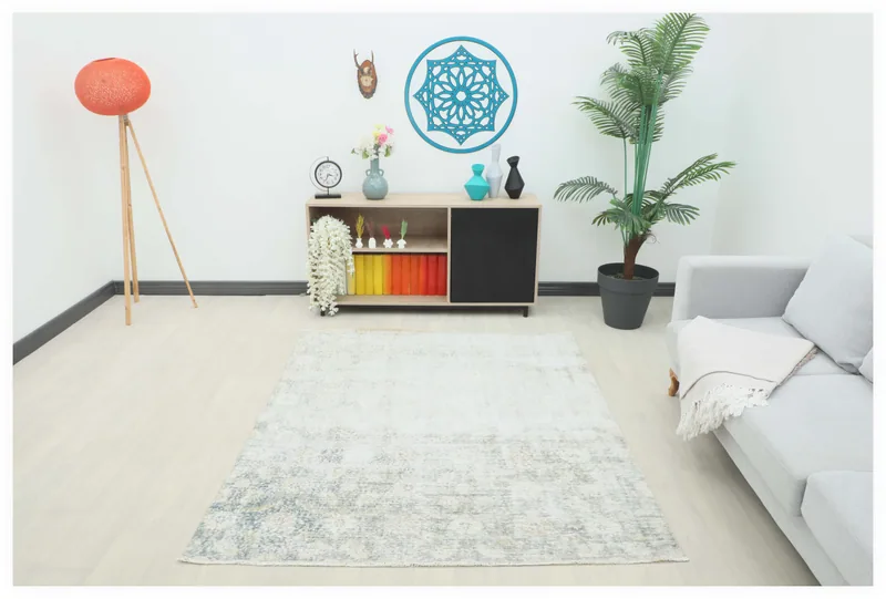 Full overhead view of the 5x6 faded blue beige geometric area rug on a white background.