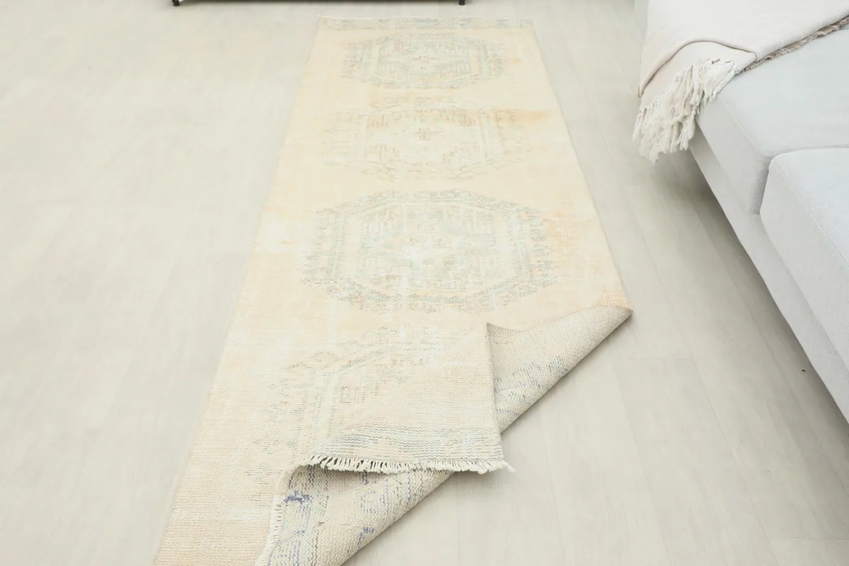 The runner rug partially folded, displaying its flexibility and material thickness