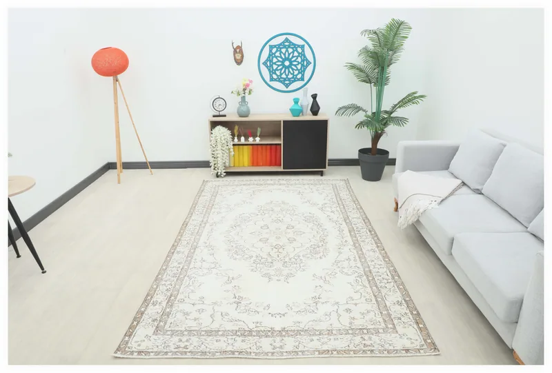 Full top view of the ivory and brown vintage Anatolian rug on a white background.