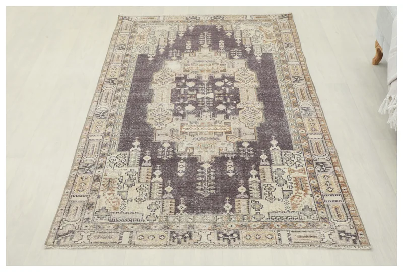 Full top view of the charcoal and beige geometric vintage Anatolian rug on a white background.