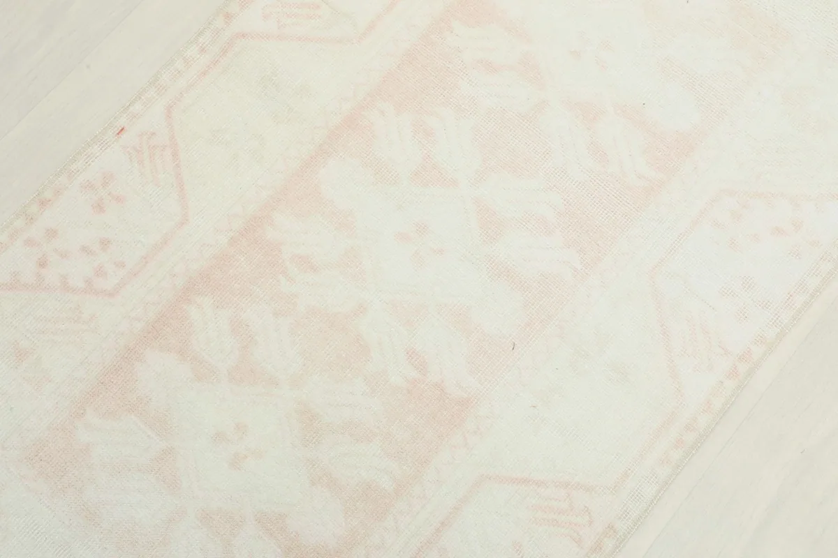 Close-up of the faded rose floral pattern and ivory field